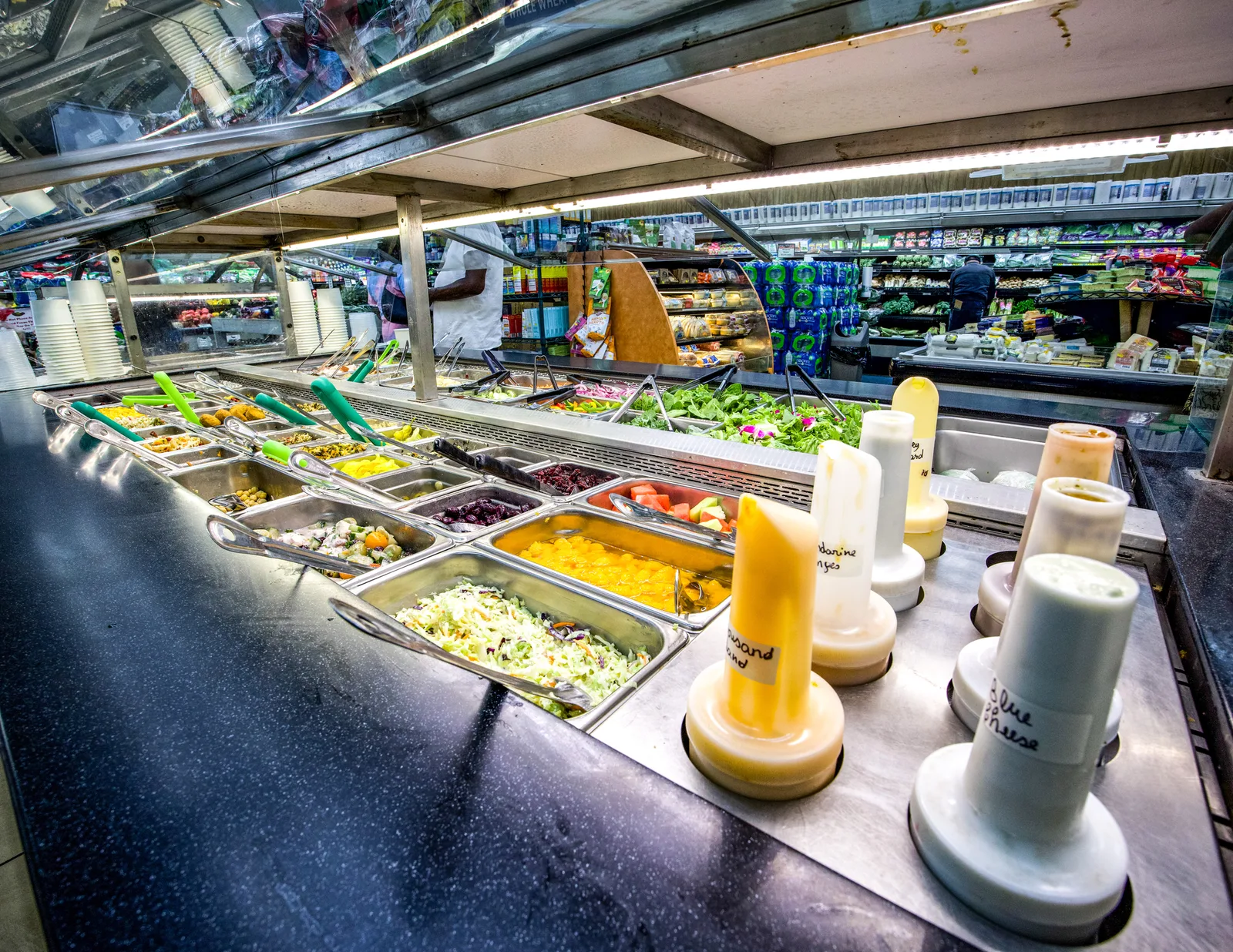 Salad bar and dressing bottles at The Fruit Bowl.