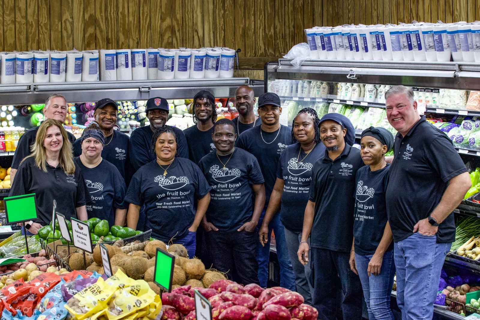 Store team gathered beside the produce display at The Fruit Bowl.