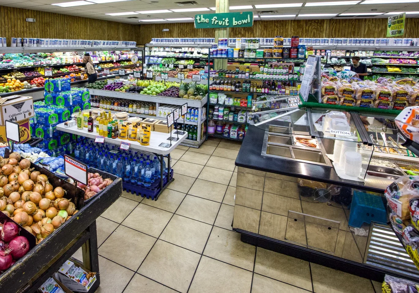 Wide view of the produce market and salad bar at The Fruit Bowl.