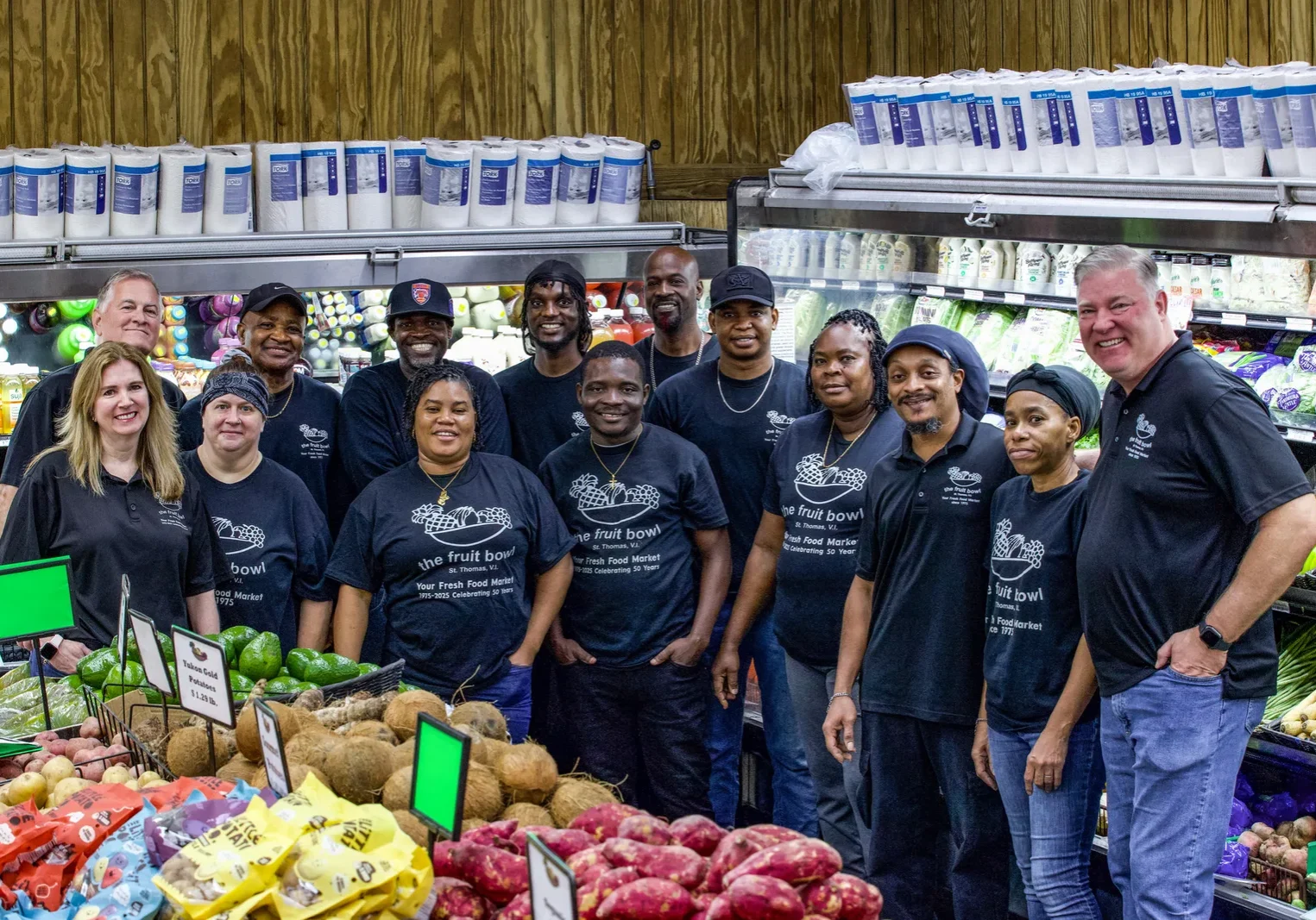Store team gathered beside the produce display at The Fruit Bowl.